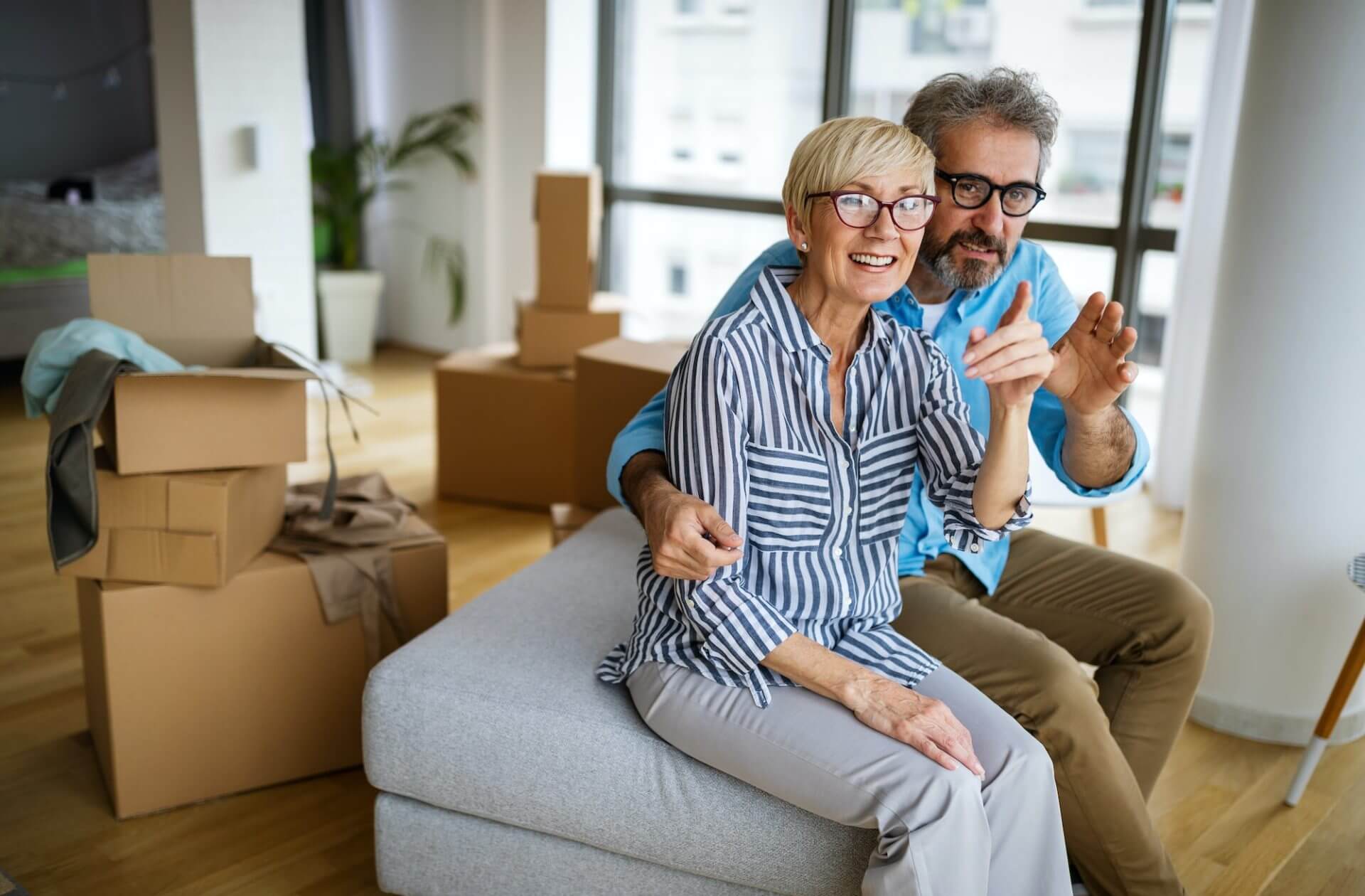 Portrait of happy senior couple in love moving in new home