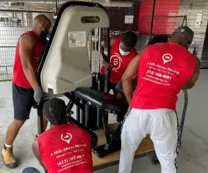 Movers carrying gym Equipment